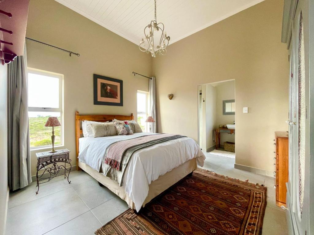 a bedroom with a bed and a chandelier at Luname`s in St Helena Bay
