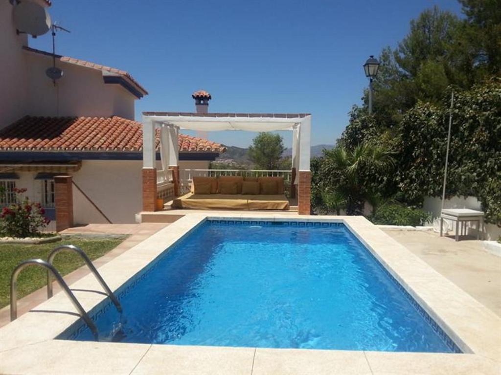 a swimming pool in front of a house at TESS Villa Ellen Maria: Space, Activity, Freedom! in Alhaurín de la Torre