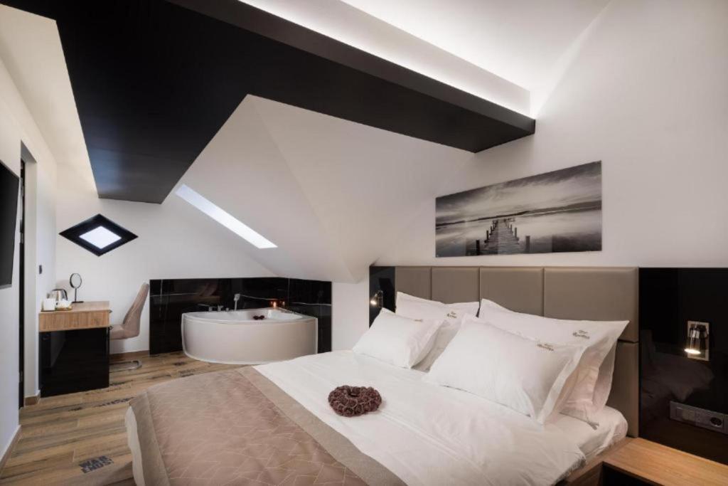 a bedroom with a large bed and a bath tub at Top rooms in Split