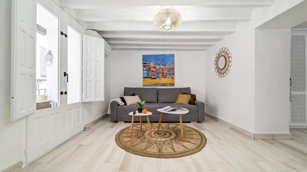 a living room with a couch and a table at POSIDONIO old town apartment in Villajoyosa