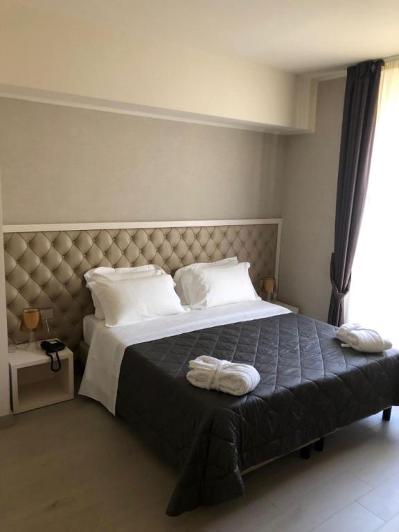 Postel nebo postele na pokoji v ubytování Hotel Cavour