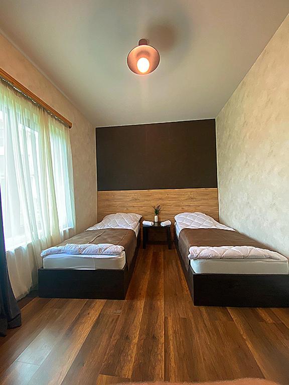 Postel nebo postele na pokoji v ubytování TwinSide Chalet Bakuriani
