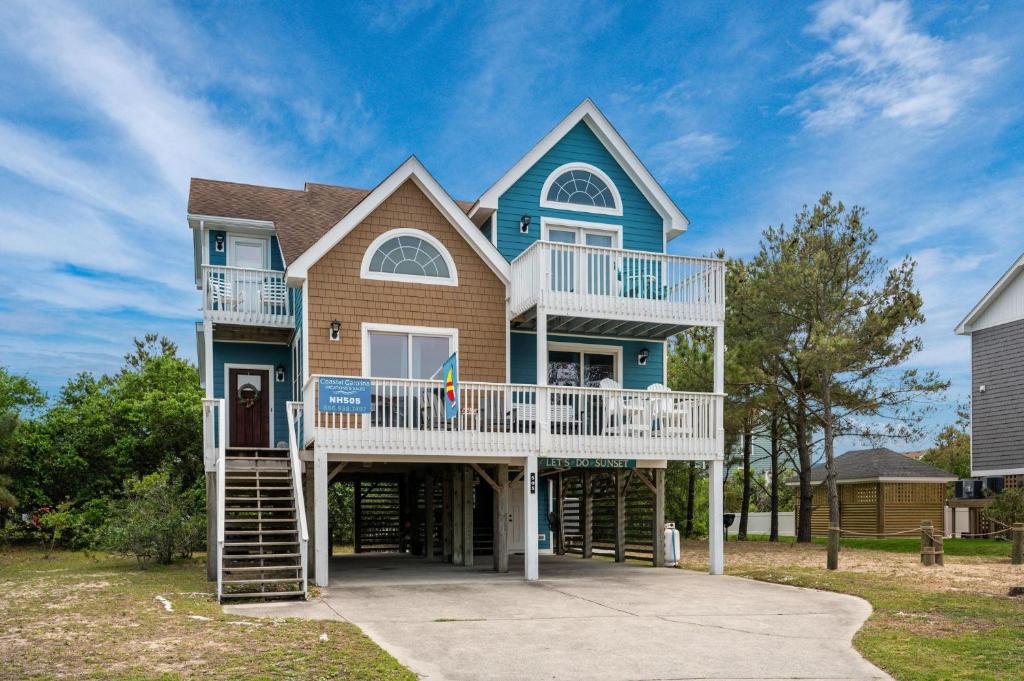 a large house with a porch and a balcony at NH505 Let's Do Sunset in Nags Head