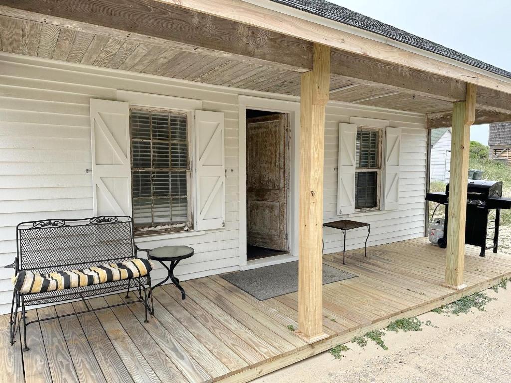 a porch of a white house with a bench at NH311B Nags Head 311B in Nags Head