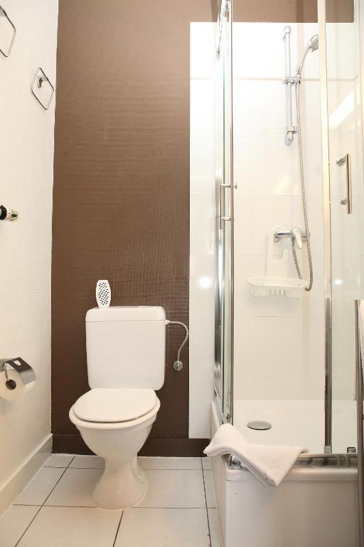a bathroom with a toilet and a shower at Eurotel in Liège