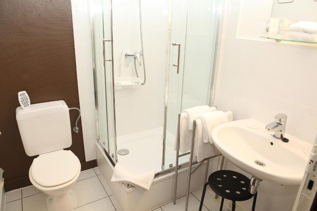 a bathroom with a toilet and a shower and a sink at Eurotel in Liège