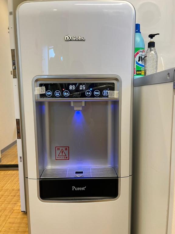 a refrigerator with its door open in a room at DainHostel2 in Tokyo