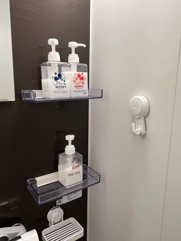 a bathroom with two soap dispensers on a door at DainHostel2 in Tokyo