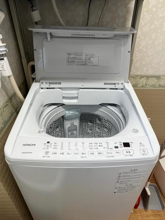 a white washer and dryer with its door open at DainHostel2 in Tokyo