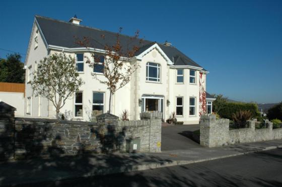 
a large white house with a large window at Caldra B&B in Buncrana
