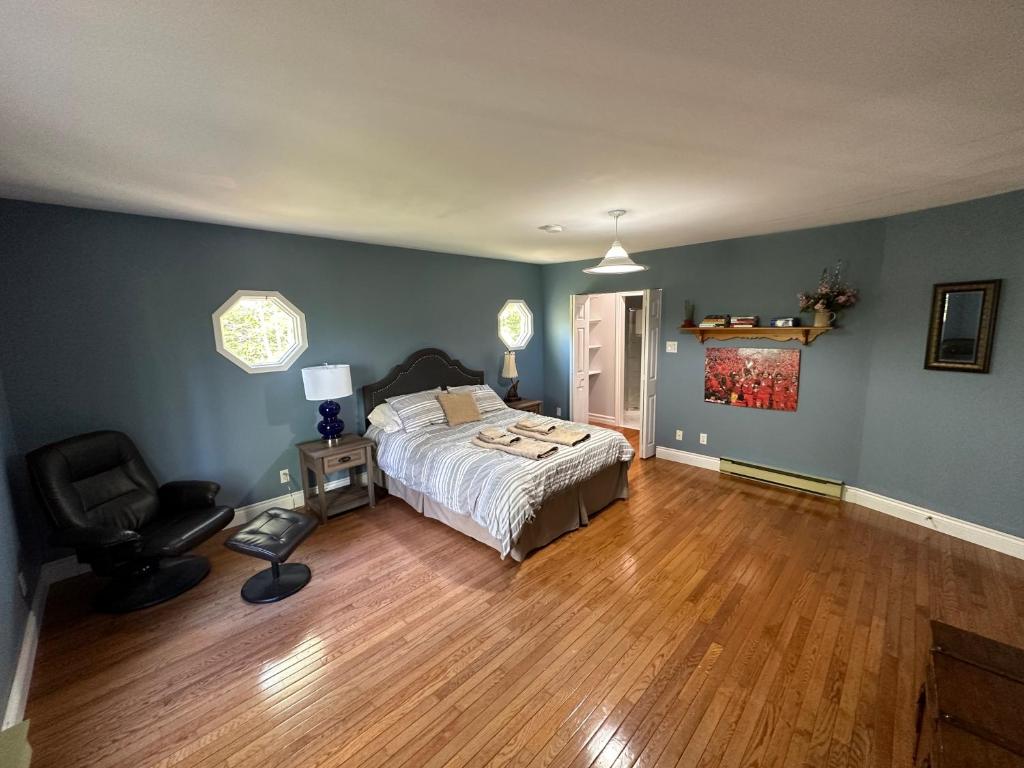 a bedroom with a bed and a chair in it at Eden Estate B&B in Reidville