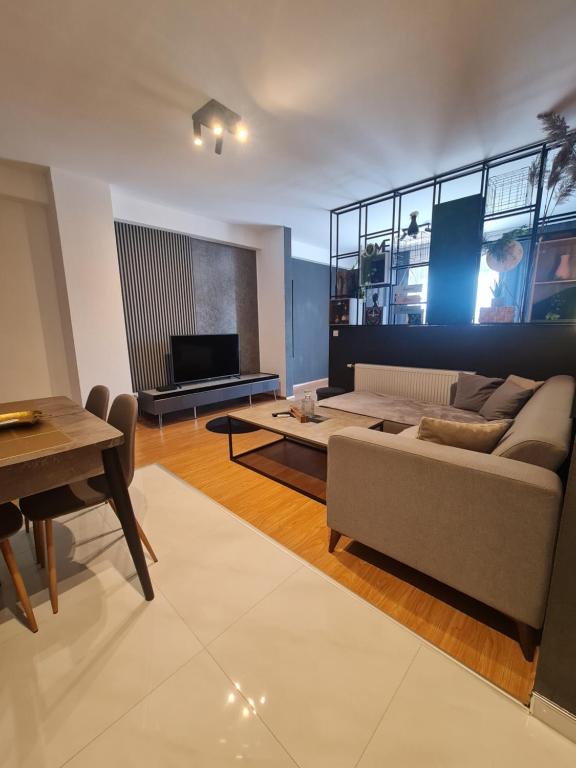 uma sala de estar com um sofá e uma mesa em Apartment 06 em Gnjilane