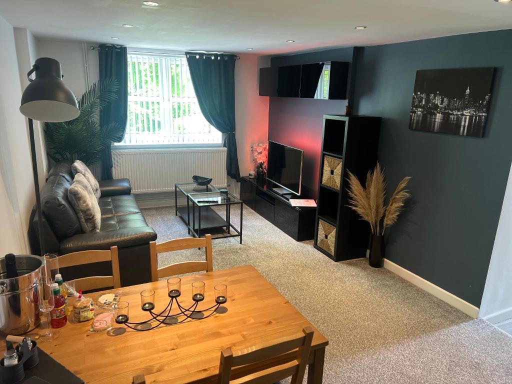 a living room with a table and a couch at Ty Daisy, Gilwern in Gilwern