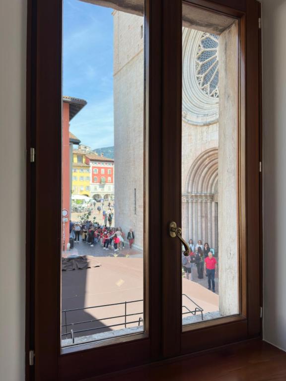an open door with a view of a city at Le finestre sul Duomo in Trento