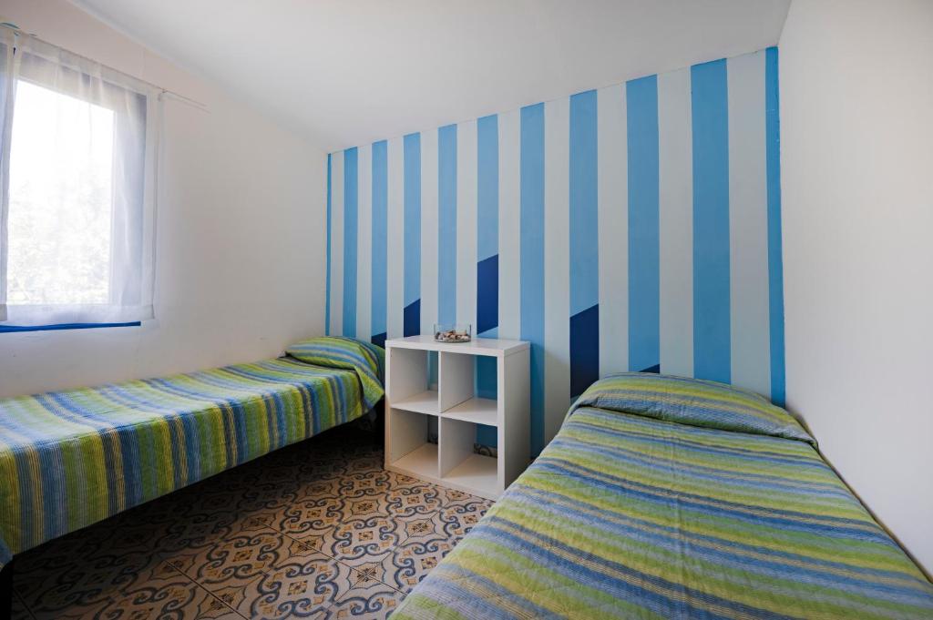Postel nebo postele na pokoji v ubytování Camping Villaggio Nettuno