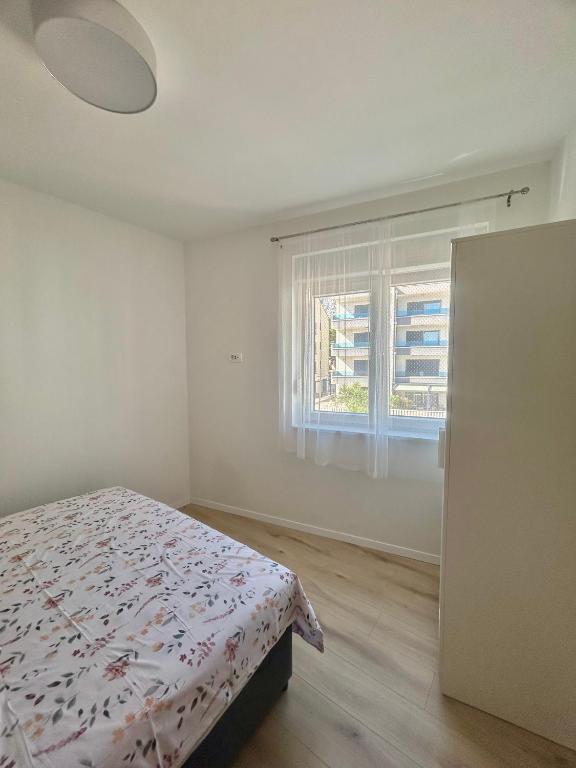 Postel nebo postele na pokoji v ubytování Apartmani Andrea