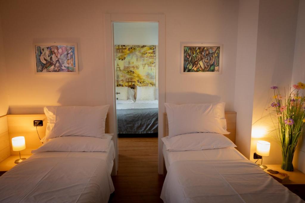 Postel nebo postele na pokoji v ubytování Hotel Vista Lago