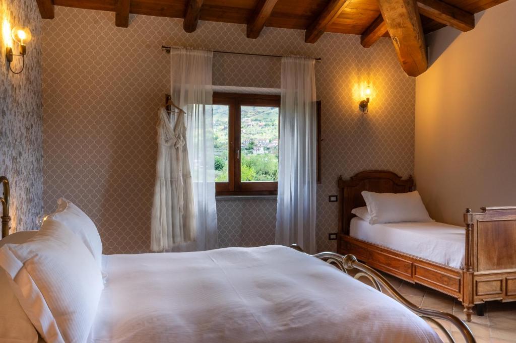 Postel nebo postele na pokoji v ubytování Casale Verdeluna Wine Resort