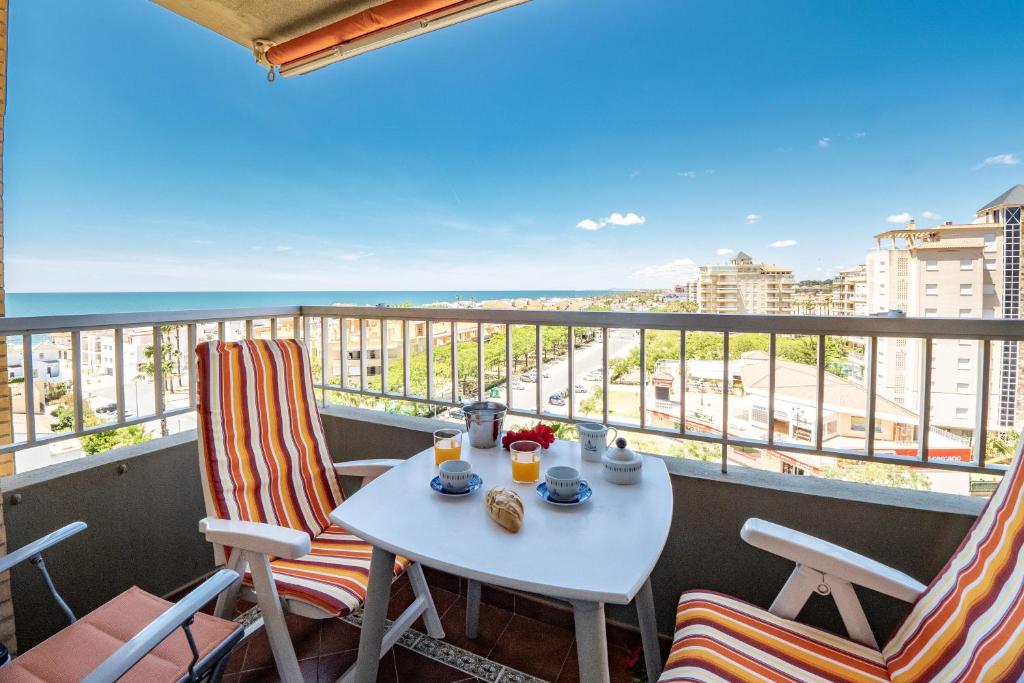 d'une table et de chaises sur un balcon avec vue sur l'océan. dans l'établissement Bonito Piso a 1 minuto de la Playa, à La Antilla
