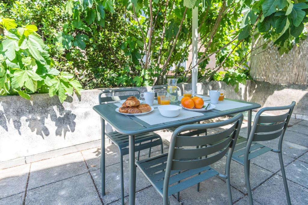 une table bleue avec une plaque de nourriture dans l'établissement Cosy Duplex Centre Ville avec grande terrasse privative, à Aix-en-Provence