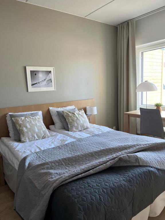 a bedroom with a large bed with a blue comforter at Ruka Chalet Front Base in Ruka