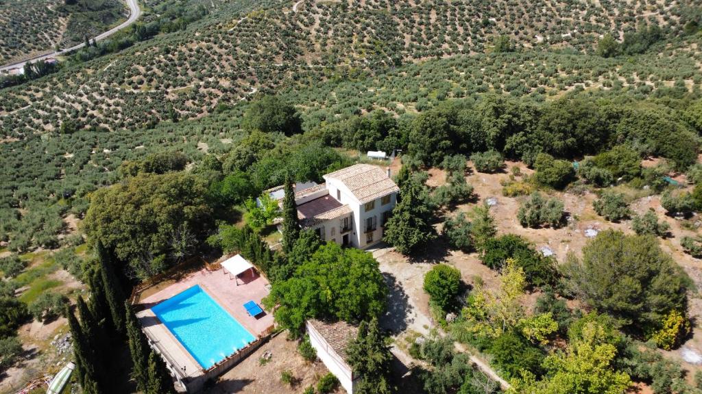 an aerial view of a house with a swimming pool at Finca Rural La Calderera in Valdepeñas de Jaén
