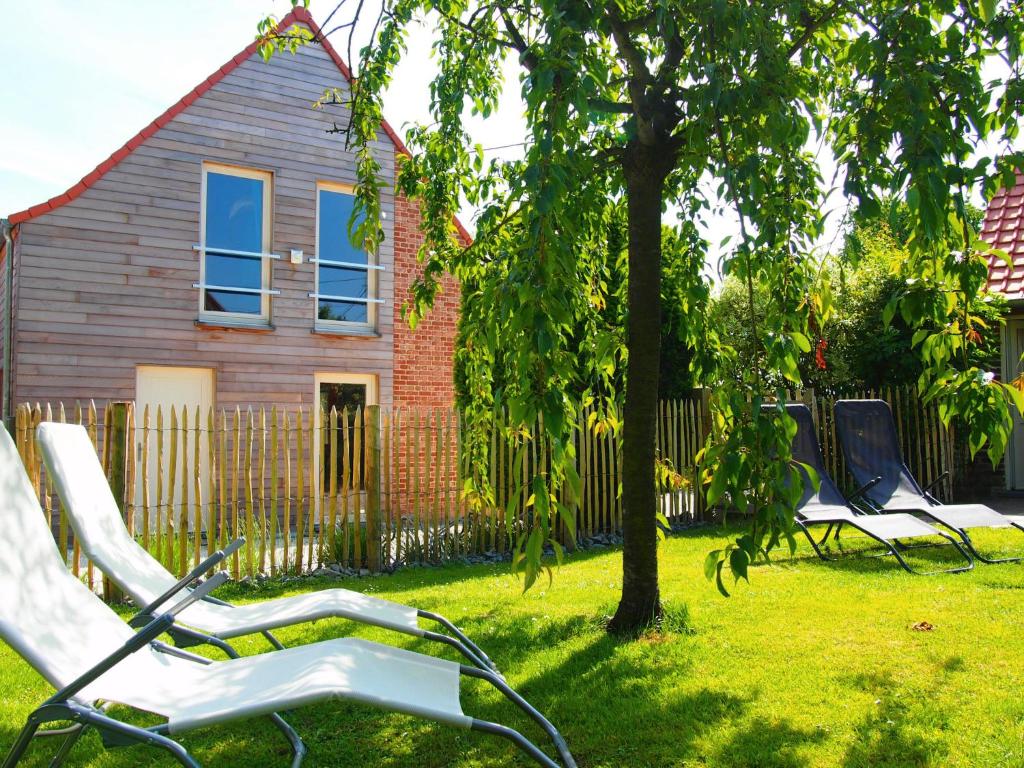 a group of chairs in a yard in front of a house at Holiday Home Gîte L'Archipel by Interhome in Ellezelles