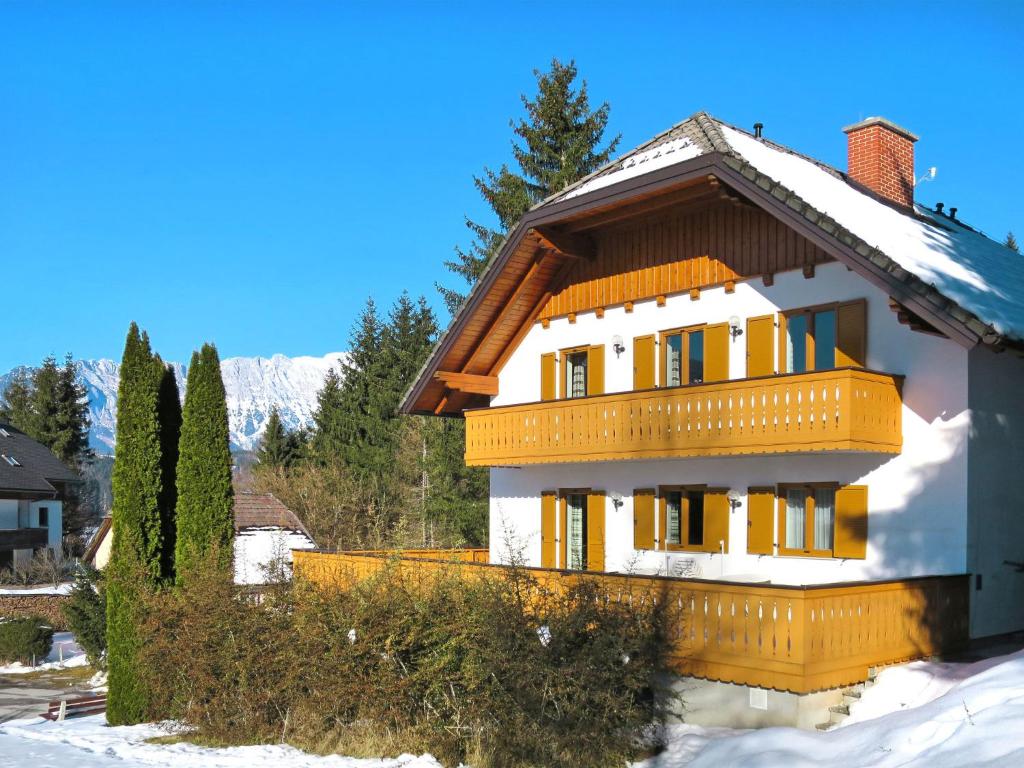 a house in the snow with trees and a mountain at Holiday Home LuxuSölk-5 by Interhome in Stein an der Enns