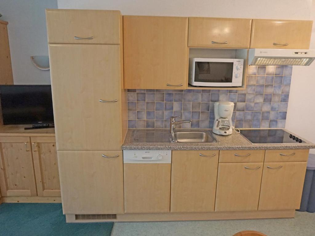małą kuchnię ze zlewem i kuchenką mikrofalową w obiekcie Apartment Diana-3 by Interhome w mieście Pettneu am Arlberg