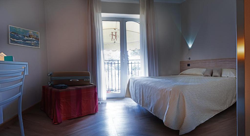 Postel nebo postele na pokoji v ubytování Hotel Savoia