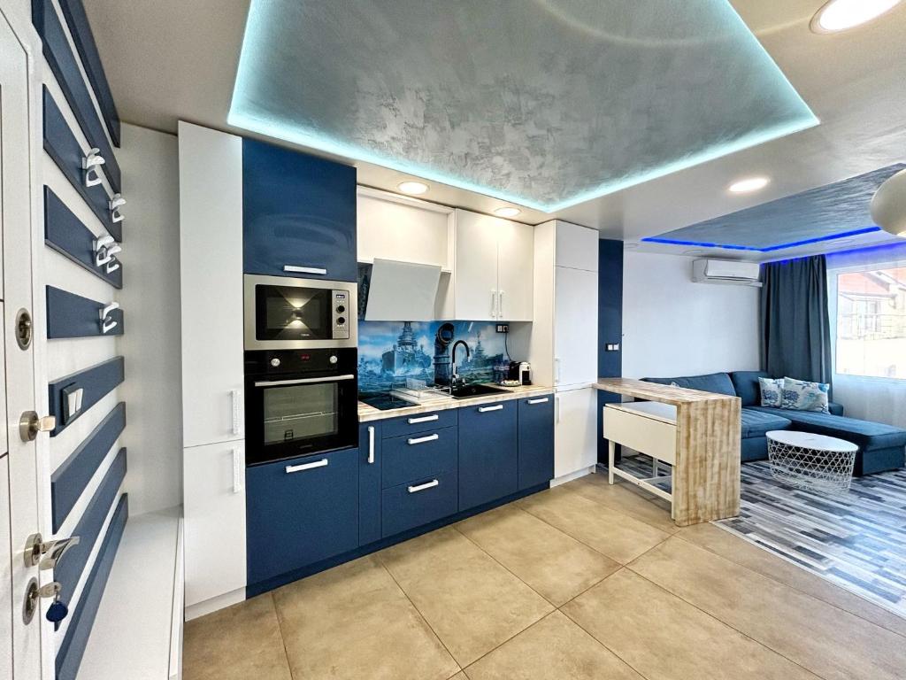 a kitchen with blue cabinets and a blue ceiling at The Captain in Varna City