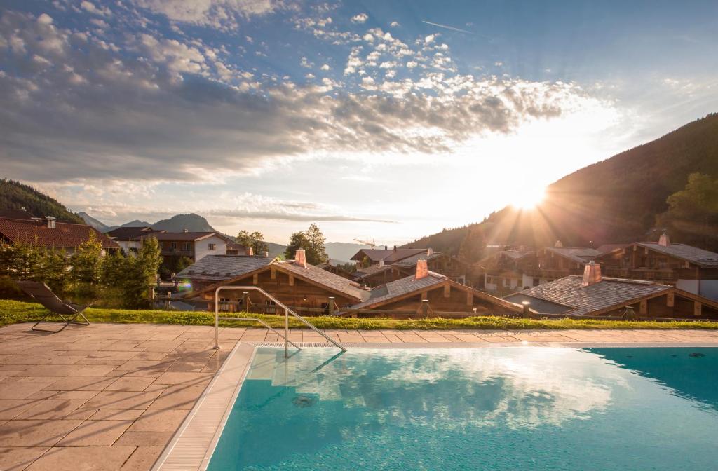 une villa avec une piscine dans un complexe dans l'établissement Alpin Chalets Oberjoch - Luxus Unterkunft mit privatem SPA und Zugang zu 3000 qm SPA Panoramahotel Oberjoch, à Bad Hindelang