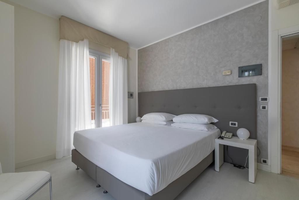 Postel nebo postele na pokoji v ubytování Hotel Gallia & Resort