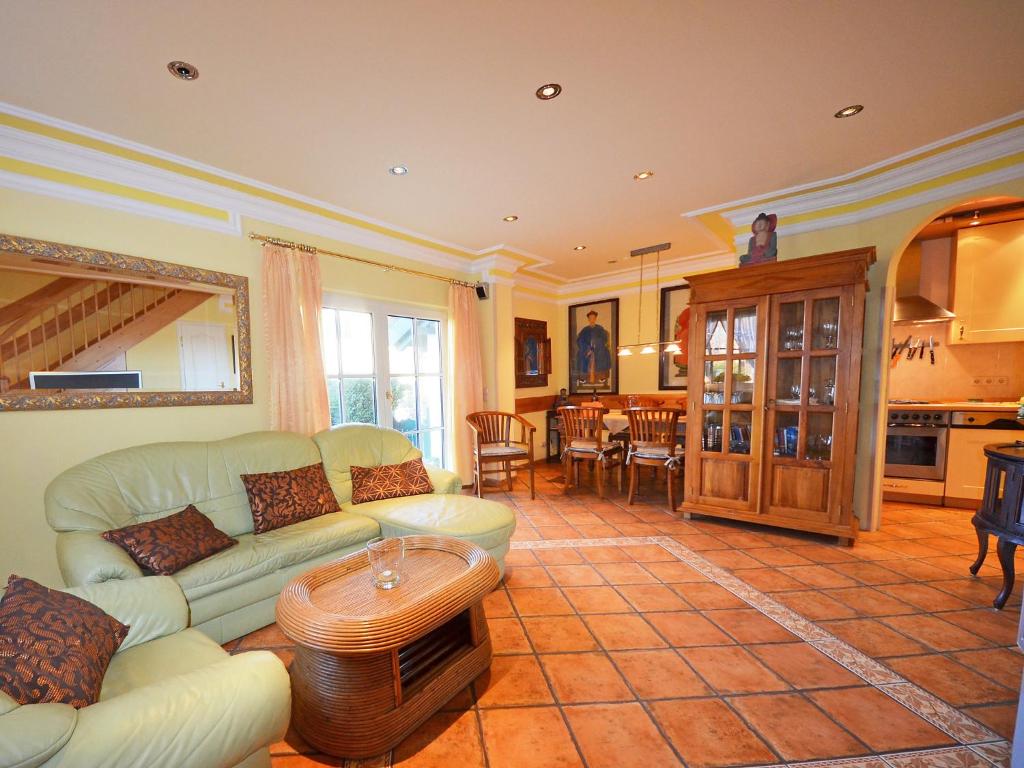 a living room with a couch and a table at Holiday Home Kirchhaus by Interhome in Groß Zicker