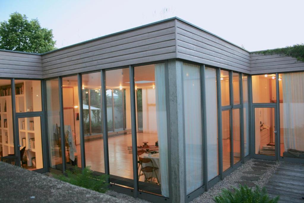 a glass extension of a house with a patio at Room Art Lovers in Marmagen