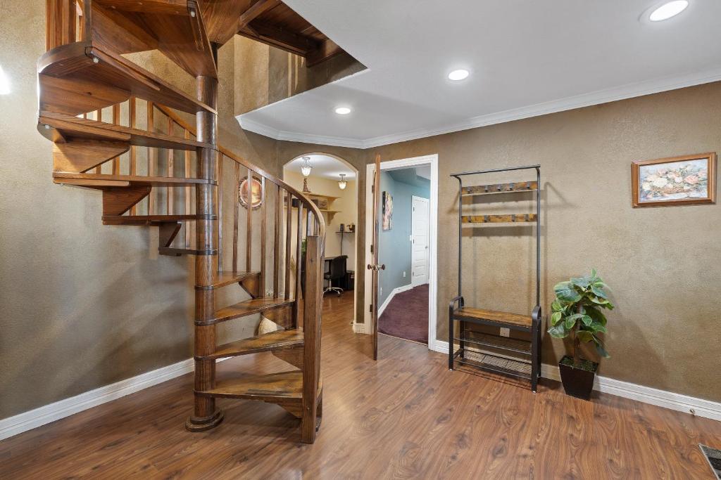 a hallway with a wooden spiral staircase in a home at Entire 2br 2ba hilltop view home Sleeps 8 pets 4 acres Jacuzzi Central AC Kingbeds Free Wifi-Parking Kitchen WasherDryer Starry Terrace Two Sunset Dining Patios Grill Stovetop Oven Fridge OnsiteWoodedHiking Wildlife CoveredPatio4pets & Birds Singing! in Marble Falls