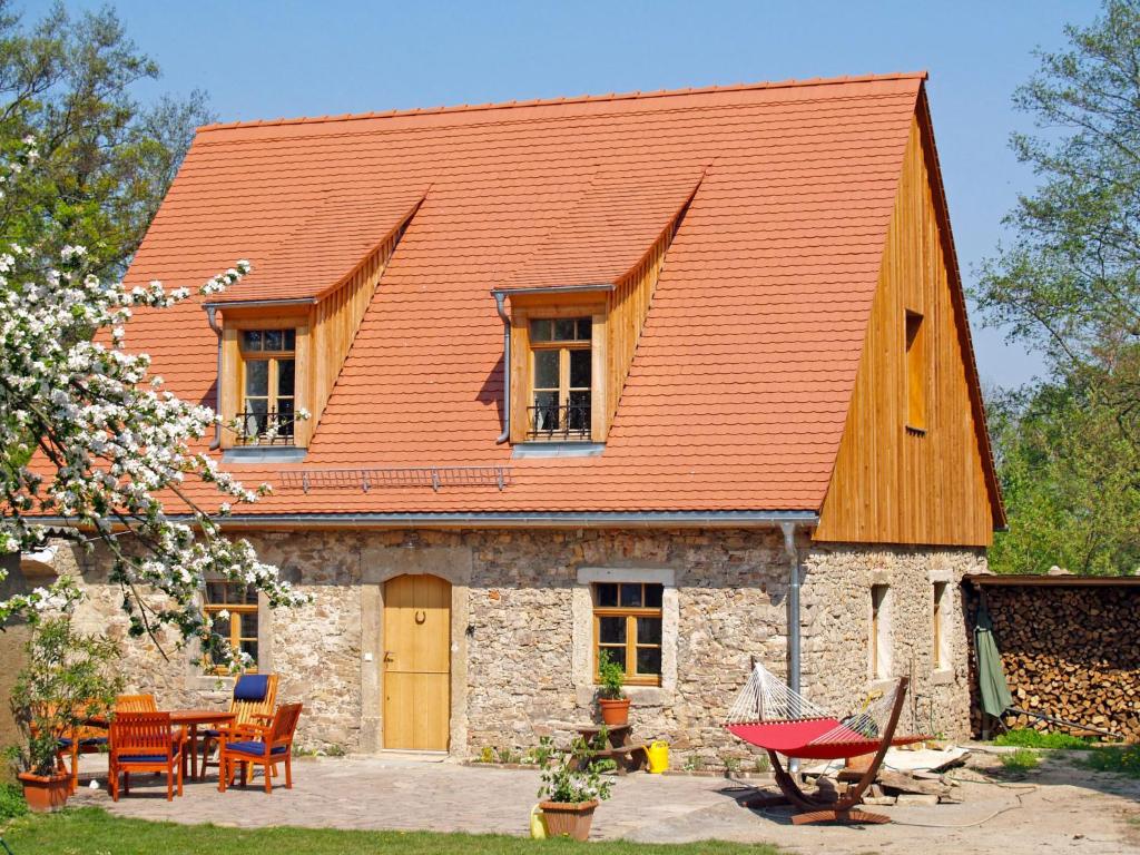 uma antiga casa de pedra com um telhado laranja em Villa Rosencottage by Interhome em Heyda