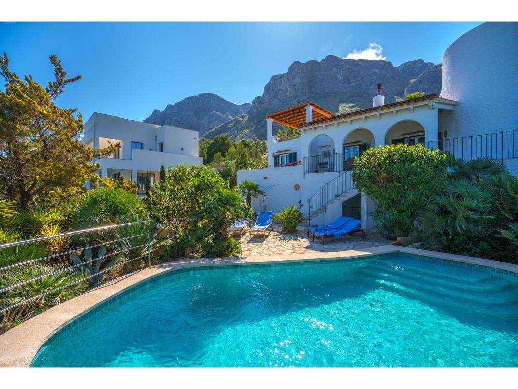 a villa with a swimming pool in front of a house at Villa Pinomar by Interhome in Colonia de Sant Pere