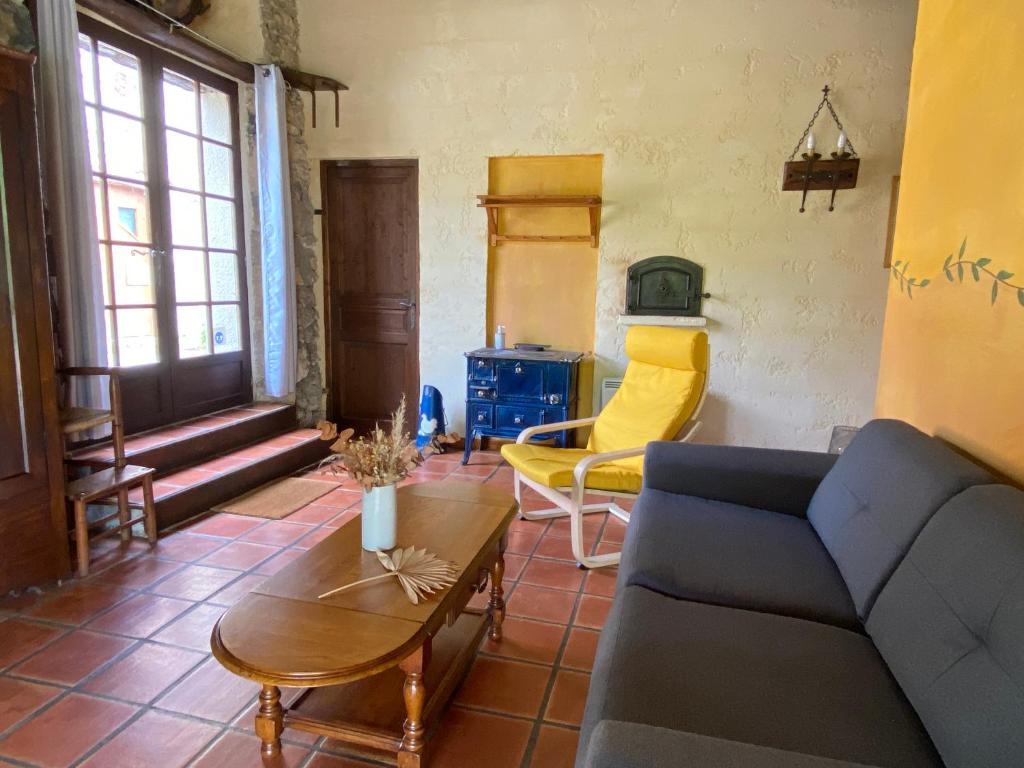 a living room with a couch and a table at Gite de Serrelongue in Montségur