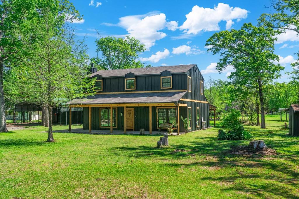 a home with a green house with a yard at Tranquil Country Escape 4 Bedrooms Pond Firepit in Greenville