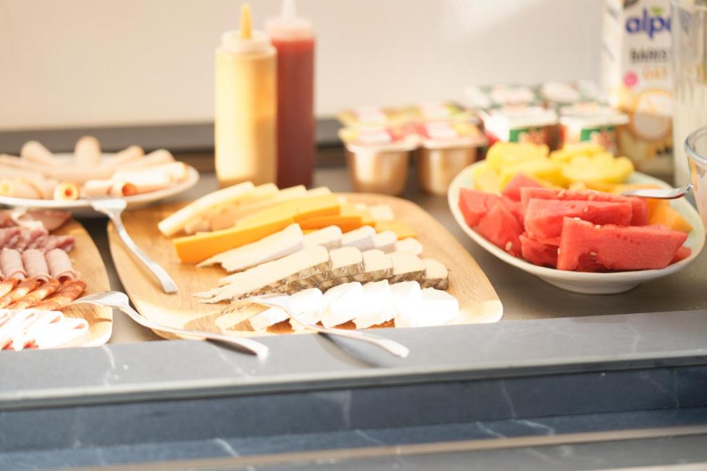 a table with different types of cheese and fruit at La Garoupe-Gardiole in Antibes