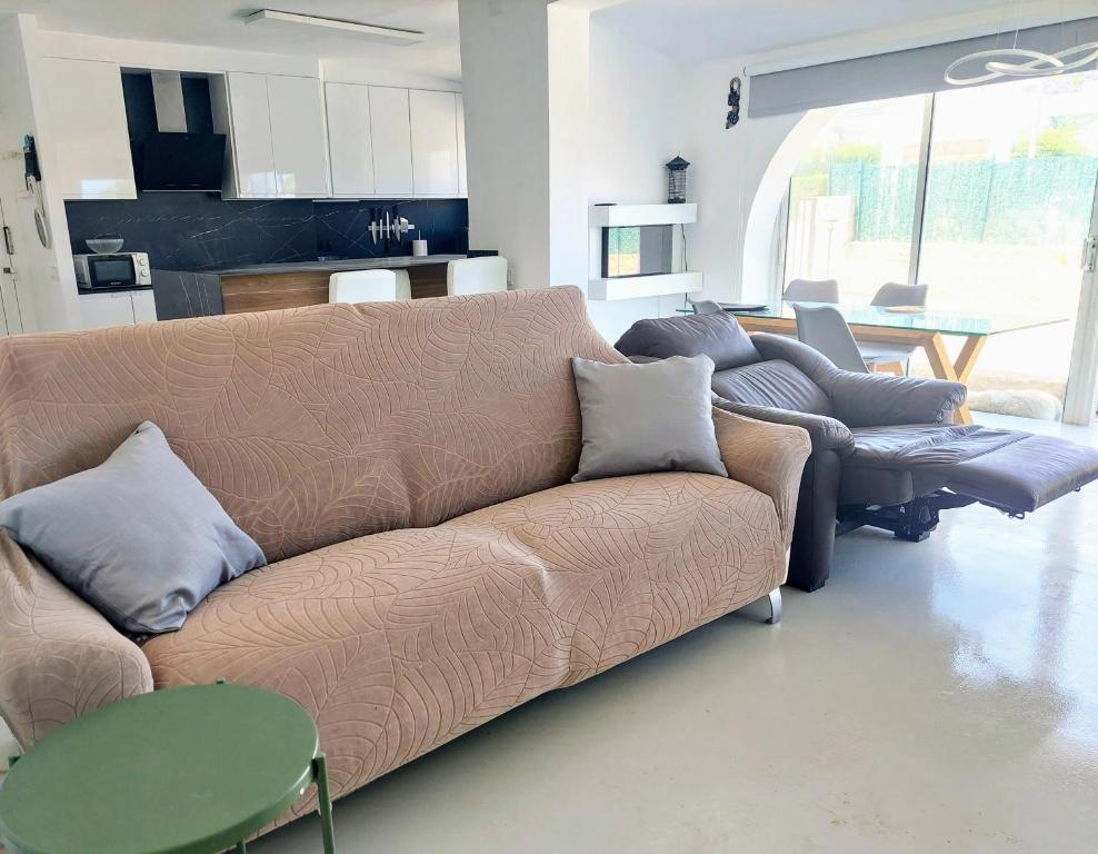 a living room with a couch and a table at CHALET CALAFAT in Calafat