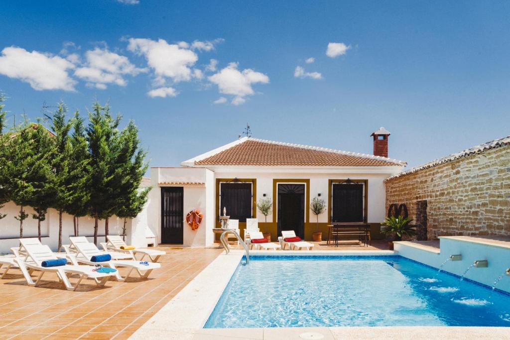 une villa avec une piscine et une maison dans l'établissement Complejo Rural en Porcuna-Jaén, à Porcuna