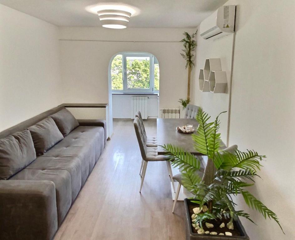 a living room with a couch and a table at Nubia Modern Apartment in Craiova