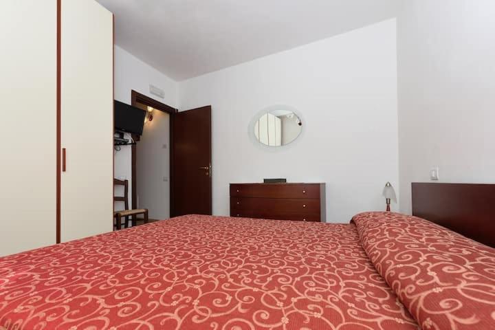 Postel nebo postele na pokoji v ubytování Casa Vacanze Dalisa Ulivo B con Parcheggio