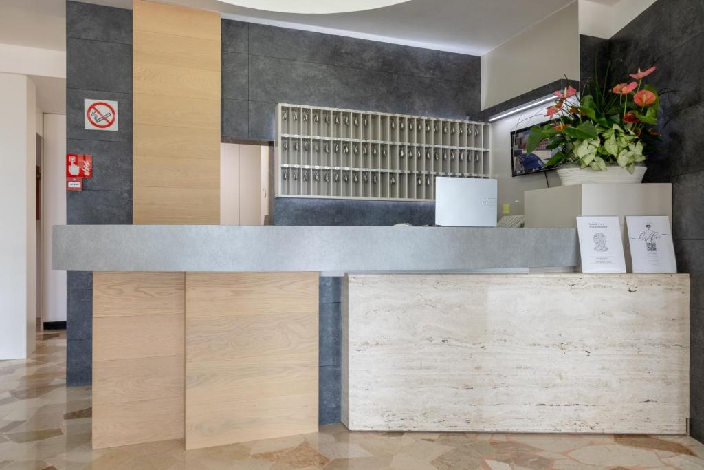 a reception desk in a lobby with wood at Hotel Continental in Caorle