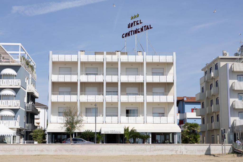 a building with a hotel sign on top of it at Hotel Continental in Caorle