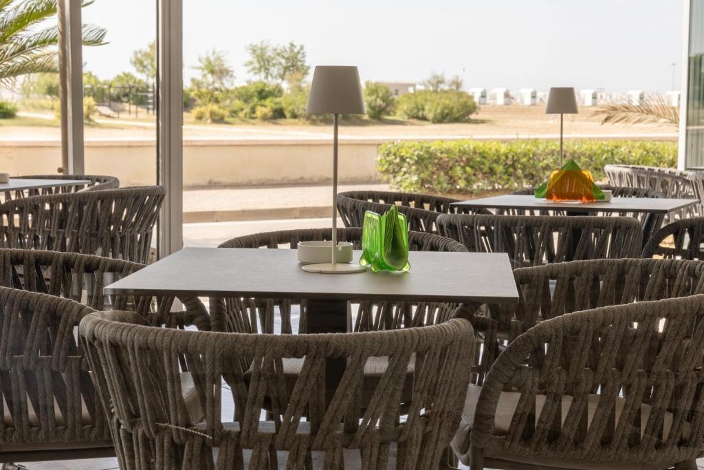 a group of tables and chairs in a restaurant at Hotel Continental in Caorle