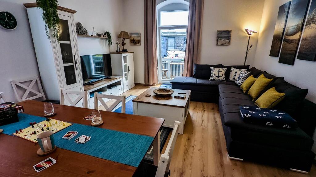 a living room with a couch and a table at Fewo Sanddüne nur wenige Minuten vom Hafen und Strand entfernt in Laboe