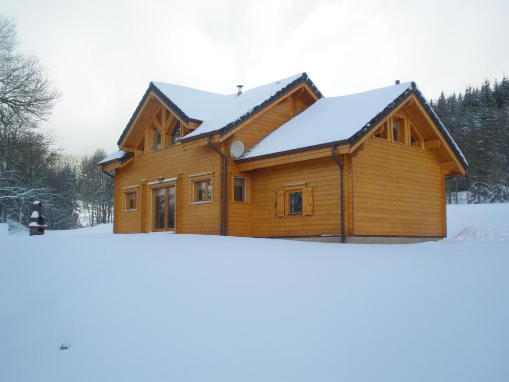 a log home with snow on the ground at Chalet des platanes Entre l'Alsace et les Vosges Nature in La Grande Fosse